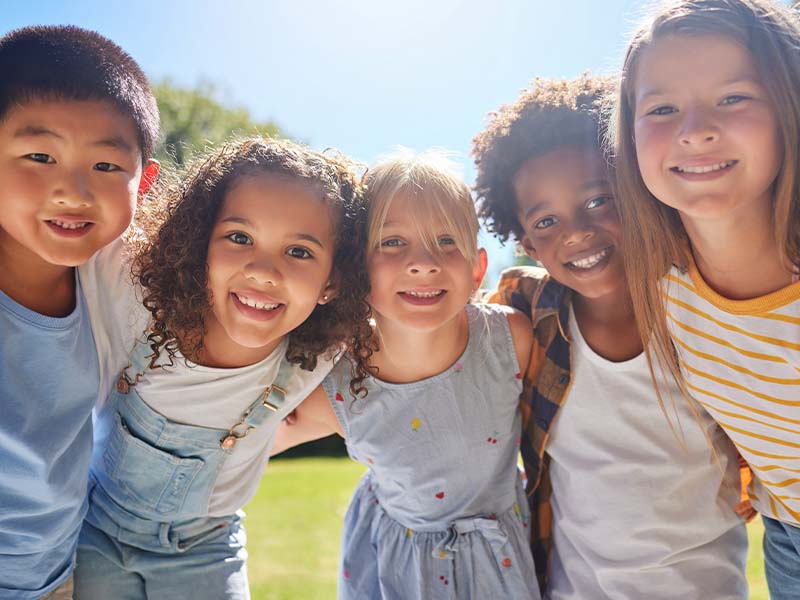 Children smiling together outdoors
